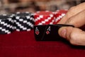 A male caucasian hand Showing a Pair of Aces in the hole, Hearts and Diamonds, on a unique deck of black faced cards with Red and Royalty Free Stock Photo