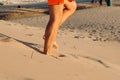 Male caucasian legs on sand dune beach. man gets down from a sand dune. Suntan, resting, relaxing. Selective focus Royalty Free Stock Photo