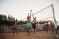 Male Caucasians, Arabs, Africans playing volleyball on the beach at sunset. Egypt. Hurghada. Golden 5 October 7, 2016 Royalty Free Stock Photo