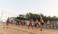 male Caucasians, Arabs, Africans playing volleyball on the beach Royalty Free Stock Photo