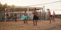 male Caucasians, Arabs, Africans playing volleyball on the beach Royalty Free Stock Photo