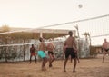 male Caucasians, Arabs, Africans playing volleyball on the beach Royalty Free Stock Photo