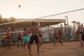 male Caucasians, Arabs, Africans playing volleyball on the beach Royalty Free Stock Photo