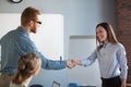 Male recruiter handshaking female job candidate after successful Royalty Free Stock Photo