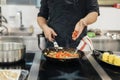 Male chef adding chili dish . High quality and resolution beautiful photo concept