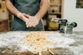 Chef against table with fettuccine, pasta machine Royalty Free Stock Photo