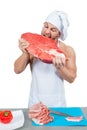Male chef bodybuilder eats raw meat.