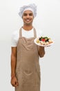 Male chef with cheese plate Royalty Free Stock Photo