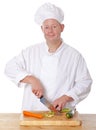 Male chef chopping vegetable on a chopping board