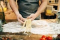 Male chef cooking dough and prepares pasta machine Royalty Free Stock Photo