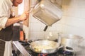 Male chef cooking fresh homemade pasta in restaurant kitchen - Bearded cook at work during dinner service - Italian style cuisine Royalty Free Stock Photo