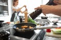 Male chef cooking in restaurant kitchen, closeup