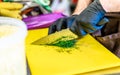 Male Chef Cutting Dill on Yellow Board Royalty Free Stock Photo