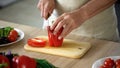 Male chef cutting fresh red pepper, cooking organic dinner salad, culinary show