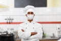 Male chef in face mask at restaurant kitchen Royalty Free Stock Photo