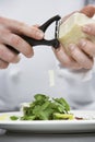 Male Chef Grating Cheese Over Salad Royalty Free Stock Photo