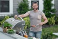 Male chef grilling and barbequing in garden. Barbecue outdoor garden party. Handsome man preparing barbecue meat Royalty Free Stock Photo