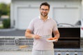 Male chef grilling and barbequing in garden. Barbecue outdoor garden party. Handsome man cook preparing barbecue salmon Royalty Free Stock Photo