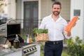 Male chef grilling and barbequing salmon fillet in garden. Barbecue outdoor garden party. Handsome man preparing Royalty Free Stock Photo