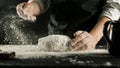 Male chef hands knead dough with flour on kitchen table Royalty Free Stock Photo