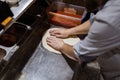 Male chef hands making pizza in the pizzeria kitchen