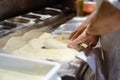 Male chef hands making pizza in the pizzeria kitchen