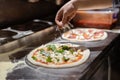 Male chef hands making pizza in the pizzeria kitchen