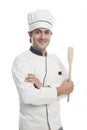 Male chef holding a spatula and smiling