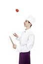Male chef juggling tomato Royalty Free Stock Photo