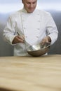 Male Chef Mixing Ingredients With Whisk