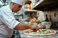 A Male Chef Prepares A Delicious, Authentic Pizza In A Pizzeria Kitchen Standard