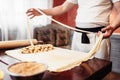 Male chef prepares dough for apple strudel Royalty Free Stock Photo