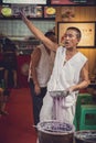 Chef making chinese noodles on market in Chongqing