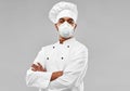 Male chef in respirator at restaurant kitchen