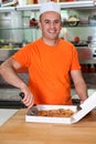 Male chef slicing pizza into pieces Royalty Free Stock Photo