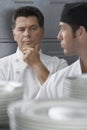 Male Chef Supervising Trainee In Kitchen Royalty Free Stock Photo