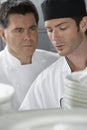 Male Chef Supervising Trainee In Kitchen Royalty Free Stock Photo