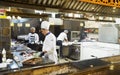 Male chefs in the kitchen prepare meat dishes