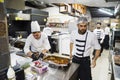 Male chefs in the kitchen prepare meat dishes