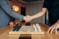 Male chess players shake hands before the game