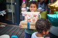 Male child holding birthday gifts