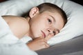 Male child with open eyes laying down on pillow