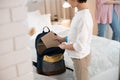 Male child in spectacles packing his schoolbag Royalty Free Stock Photo