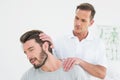 Male chiropractor doing neck adjustment Royalty Free Stock Photo