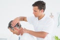 Male chiropractor doing neck adjustment Royalty Free Stock Photo