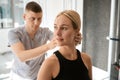 Male chiropractor working with a young client in wellness center