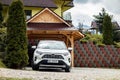 Toyota RAV4 Hybrid SUV car in front of vacation rental house in High Tatras, Poland Royalty Free Stock Photo