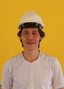 Male civil engineer with white helmet and wear white T-shirt on yellow background