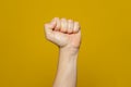 Male clenched fist, isolated on an orange background. Strong man's hand with a fist. Alpha. Protest Royalty Free Stock Photo