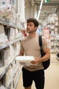 Man choosing bedsheets in shop